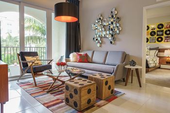 a living room with a couch and chairs and a table